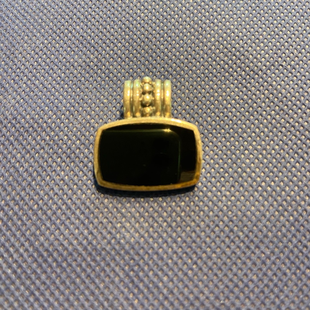 Sterling silver and onyx pendant.